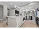 Bright kitchen with white marble island, stainless steel appliances, dark cabinets and modern lighting at 1815 Avery Way, Castle Rock, CO 80109