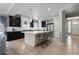 Modern kitchen featuring a spacious island with barstool seating, dark cabinets, and stainless steel appliances at 1815 Avery Way, Castle Rock, CO 80109