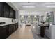 Open concept living space with light wood floors, modern furniture and decor, and dark wood cabinets at 1815 Avery Way, Castle Rock, CO 80109