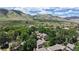 Breathtaking aerial view capturing townhomes surrounded by lush greenery and majestic mountain vistas at 1006 Homestake Dr # 1D, Golden, CO 80401