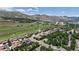 Expansive aerial view showcases residential area with mature trees, golf course, and mountain backdrop at 1006 Homestake Dr # 1D, Golden, CO 80401
