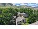 Scenic aerial view of townhomes surrounded by lush greenery and rolling hills under a blue sky at 1006 Homestake Dr # 1D, Golden, CO 80401
