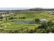Scenic aerial view of a lush green golf course with a pond, perfect for outdoor recreation at 1006 Homestake Dr # 1D, Golden, CO 80401