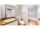 Bathroom features granite counters, white cabinets, and wood floors at 1006 Homestake Dr # 1D, Golden, CO 80401