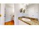 Bright bathroom featuring granite counters and dual vanity mirrors at 1006 Homestake Dr # 1D, Golden, CO 80401