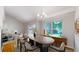 Bright dining area featuring an elegant chandelier, hardwood floors and backyard views at 1006 Homestake Dr # 1D, Golden, CO 80401