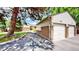 View of the exterior with a multi-car garage and a brick wall along the driveway at 1006 Homestake Dr # 1D, Golden, CO 80401