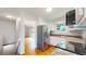 Bright kitchen boasts stainless steel appliances and granite counters, flowing into open-plan living space and stairs at 1006 Homestake Dr # 1D, Golden, CO 80401