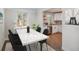 Dining room area with marble table, opening into a remodeled kitchen at 1362 Wolff St, Denver, CO 80204