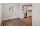 Dining area and kitchen showcasing hardwood floors, and white cabinetry at 1362 Wolff St, Denver, CO 80204