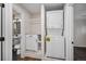 Convenient laundry area with stackable washer/dryer unit and built-in shelving for storage at 1362 Wolff St, Denver, CO 80204