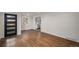 Open-concept living room featuring hardwood floors and a view into the updated kitchen at 1362 Wolff St, Denver, CO 80204