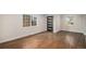Sun-drenched living room with hardwood floors, modern front door, and a large window at 1362 Wolff St, Denver, CO 80204