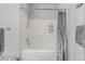 A modern bathtub with white tile and gray curtain, offering a relaxing space at 457 Black Feather Loop # 702, Castle Rock, CO 80104