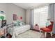 Bright bedroom with large window, daybed and soft decor elements at 457 Black Feather Loop # 702, Castle Rock, CO 80104