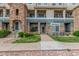 Inviting condo exterior featuring stone accents, a well-maintained lawn, and a sidewalk to the front door at 457 Black Feather Loop # 702, Castle Rock, CO 80104