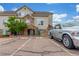 Beautiful townhome exterior featuring stone accents, tan siding, and assigned parking spaces in a well-maintained community at 457 Black Feather Loop # 702, Castle Rock, CO 80104