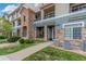 Attractive condo exterior featuring stone accents, well-maintained landscaping, and inviting walkways at 457 Black Feather Loop # 702, Castle Rock, CO 80104