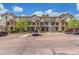 Spacious townhome complex boasting stone accents, multiple units, assigned parking, and landscaped grounds at 457 Black Feather Loop # 702, Castle Rock, CO 80104