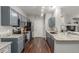 Well-lit kitchen with stainless steel appliances and grey cabinets and granite countertops at 457 Black Feather Loop # 702, Castle Rock, CO 80104