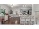 Open kitchen with stainless steel appliances, granite countertops, and bar seating overlooking the living area at 457 Black Feather Loop # 702, Castle Rock, CO 80104
