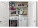 A functional laundry room with a washing machine, dryer, and storage shelves at 457 Black Feather Loop # 702, Castle Rock, CO 80104