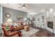 Inviting living room with hardwood floors, fireplace, and cozy seating arrangement under a ceiling fan at 457 Black Feather Loop # 702, Castle Rock, CO 80104