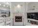 Stylish living room showcasing a fireplace, hardwood floors, and open layout connected to the kitchen at 457 Black Feather Loop # 702, Castle Rock, CO 80104