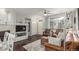 Bright living room featuring hardwood floors, a fireplace, and comfortable seating with natural light at 457 Black Feather Loop # 702, Castle Rock, CO 80104