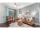 Cozy living room featuring hardwood floors, comfortable seating, and ample natural light from a large window at 457 Black Feather Loop # 702, Castle Rock, CO 80104