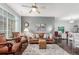 Spacious living room with hardwood floors, fireplace, and comfortable seating bathed in natural light at 457 Black Feather Loop # 702, Castle Rock, CO 80104