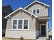 Charming two-story home featuring a stone base and vertical siding under a blue sky at 2102 Wagon Wheel Aly, Brighton, CO 80601