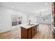 Bright, open kitchen with a large island, sliding glass door, and wood flooring at 2102 Wagon Wheel Aly, Brighton, CO 80601
