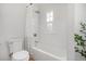 Bathroom with white subway tile, a bathtub with shower, and natural light from window at 2272 Jay St, Edgewater, CO 80214