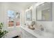 Bright bathroom featuring double vanity, large window, and modern fixtures at 2272 Jay St, Edgewater, CO 80214