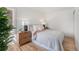 Cozy bedroom with a neutral color palette, wood floors, and decorative bedside lamps at 2272 Jay St, Edgewater, CO 80214