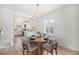 Open-concept dining area with modern chandelier, hardwood floors, and access to the kitchen at 2272 Jay St, Edgewater, CO 80214