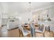 Open-concept dining area with hardwood floors and views of the living room and kitchen at 2272 Jay St, Edgewater, CO 80214