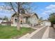 Charming home with new siding, a detached garage, and a gravel driveway at 2272 Jay St, Edgewater, CO 80214
