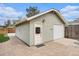 Detached garage with light green siding and a white garage door, complemented by a paved brick driveway at 2272 Jay St, Edgewater, CO 80214