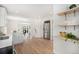 Kitchen view highlighting stainless steel refrigerator, open shelving, and view into dining area at 2272 Jay St, Edgewater, CO 80214