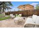 Charming backyard patio featuring cozy seating, a shade umbrella, and lush greenery, perfect for outdoor relaxation at 2272 Jay St, Edgewater, CO 80214
