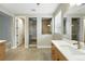Bathroom featuring a double sink vanity, large mirrors, and an enclosed tiled shower at 3370 Backdrop Ct, Castle Rock, CO 80108