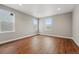 Comfortable bedroom with hardwood floors and ample natural light from multiple windows at 3370 Backdrop Ct, Castle Rock, CO 80108