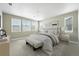 Bright bedroom with white linens, neutral decor, and sun-drenched windows at 3370 Backdrop Ct, Castle Rock, CO 80108