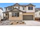 Charming two-story home featuring a stone facade, attached garage, and manicured front yard at 3370 Backdrop Ct, Castle Rock, CO 80108