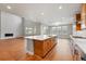 Modern kitchen and living room with wood floors, white counters and large windows at 3370 Backdrop Ct, Castle Rock, CO 80108