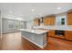 Bright kitchen boasts stainless steel appliances, custom cabinets and large center island at 3370 Backdrop Ct, Castle Rock, CO 80108