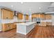 Spacious kitchen features custom cabinets, center island, stainless appliances and wood floors at 3370 Backdrop Ct, Castle Rock, CO 80108