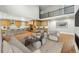 Open-concept living room and kitchen area with modern furnishings and an upstairs balcony at 3370 Backdrop Ct, Castle Rock, CO 80108